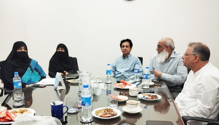 President Ayesha Amir, Chairman Dr. Aman Khan, and Advisory Board members engaged in a discussion around a conference table during Baithak School Network’s meeting in Karachi.
