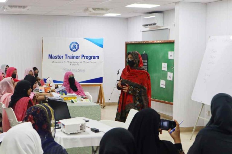 Workshop trainer explaining innovative teaching methods to Baithak School principals and subject teachers.