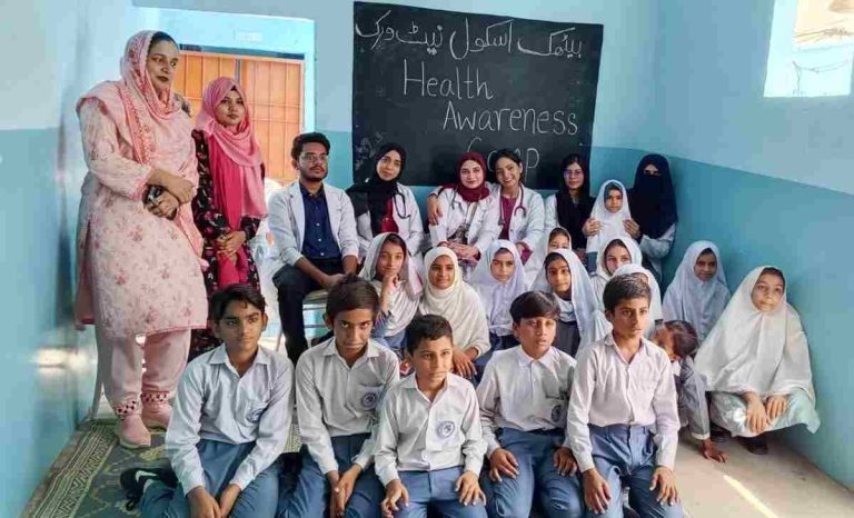 Group photo of Baithak School Qaid-e-Azam Colony students with final-year medical students from Liaquat National Hospital during the health awareness session.