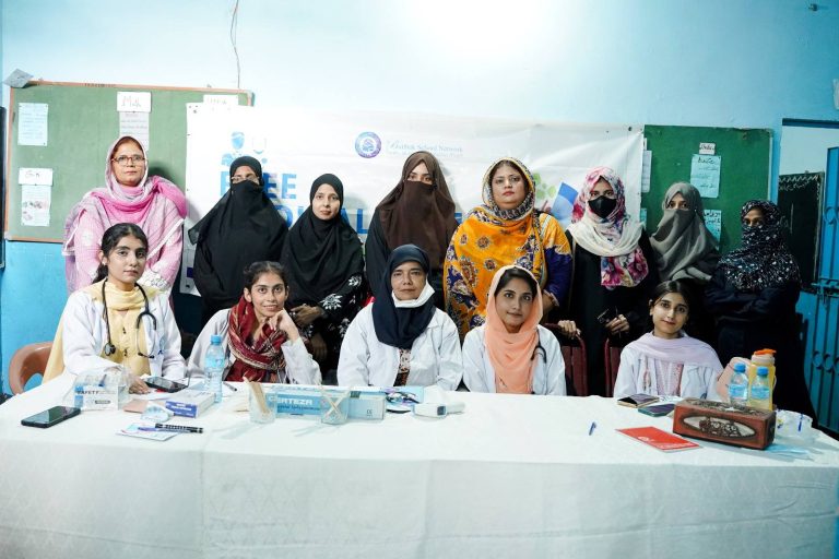 PIMA doctors with Baithak School teachers in a group photo during the health screening camp at Lines Area Campus
