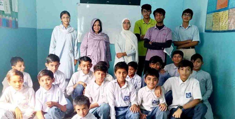 Smiling students from both schools gathered for a group photograph at Baithak School Qaid-e-Azam Colony under the CCDP 2025 initiative.