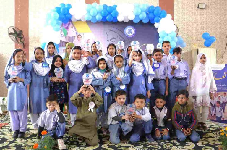 Award-winning students standing together on stage during the Ibn-e-Sina Olympiad ceremony.