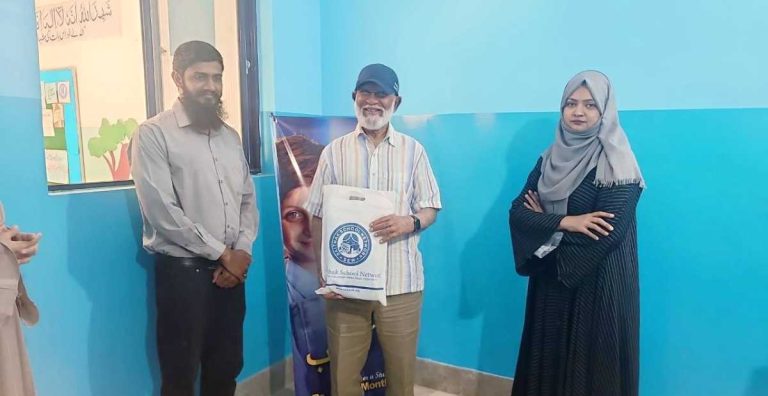 Baithak School team honoring Dr. Shabbir Syed with a souvenir for his generous support.