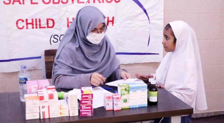 Doctor examining a student during the SOCH medical camp at Baithak School.