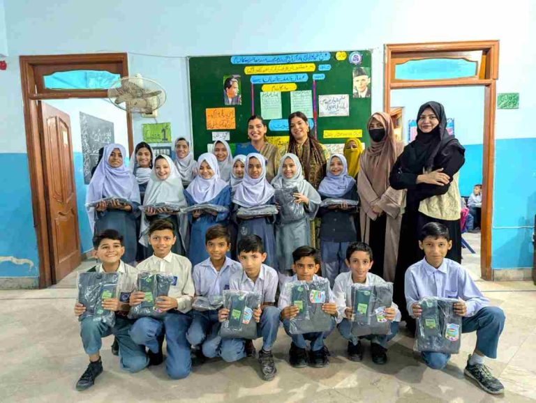 Group photo of visiting sponsors with students at Baithak School in Lyari.