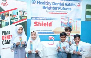 Children at Baithak School Sikanderabad proudly showing their new dental care kits with joyful smiles during the awareness session.