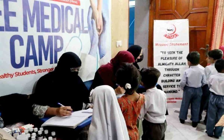 Doctors examining students during free medical camp at Baithak School Dubban Pura with PIMA Women Wing Lahore.