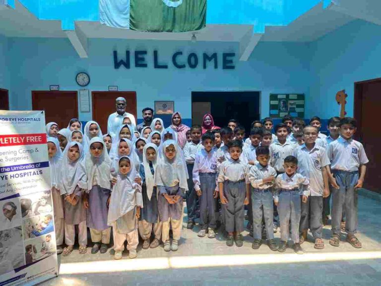 Students and eye care professionals posing together after successful vision screening camp at Baithak School.